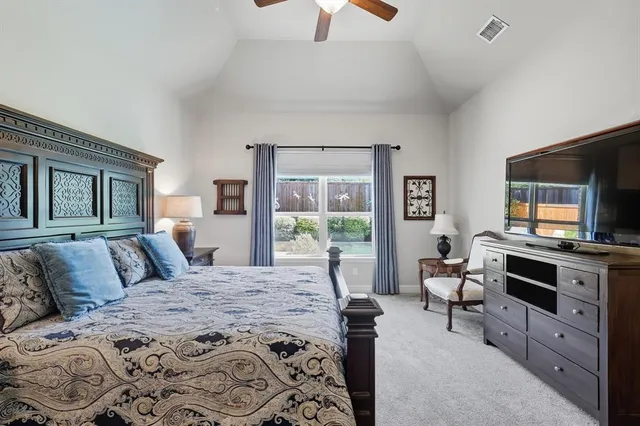 a bedroom with a bed and a television