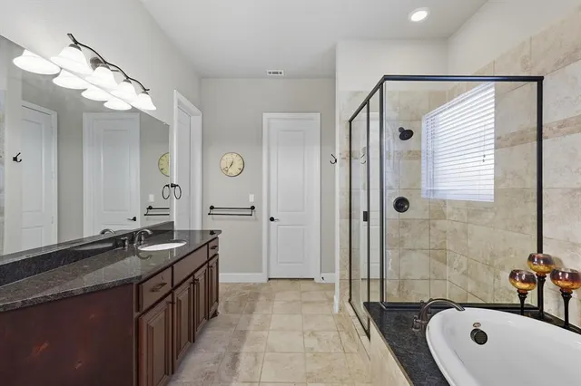 a bathroom with a double vanity sink mirror and shower