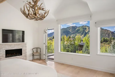 a view of a livingroom with a fireplace and window