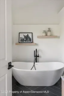 a white bath tub sitting in a bathroom
