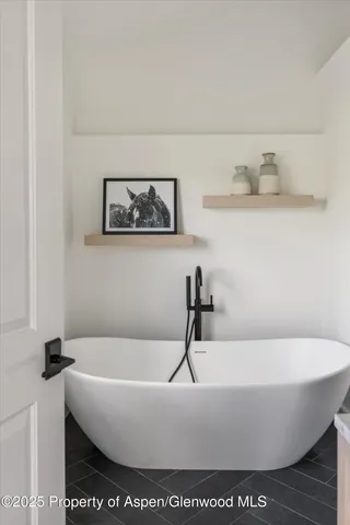 a white bath tub sitting in a bathroom