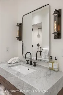 a bathroom with a sink vanity and mirror