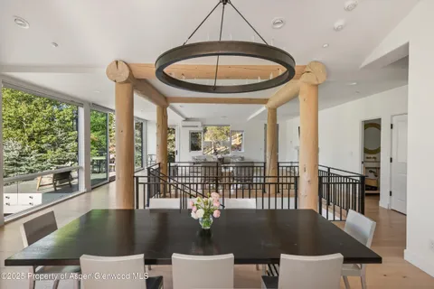a view of a dining room with furniture wooden floor and chandelier