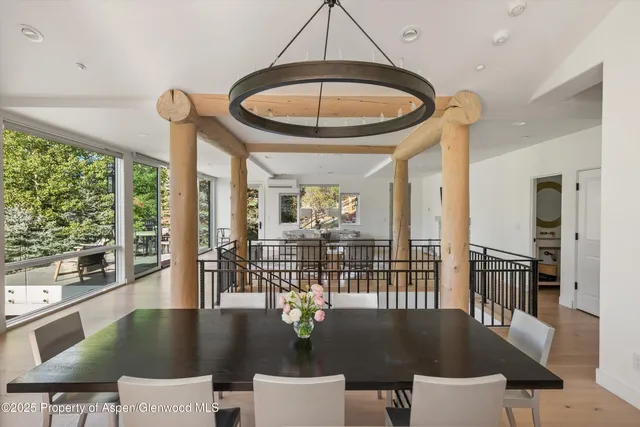 a view of a dining room with furniture wooden floor and chandelier