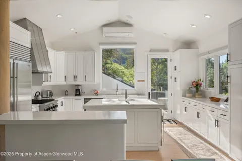 a kitchen with stainless steel appliances a sink stove and cabinets