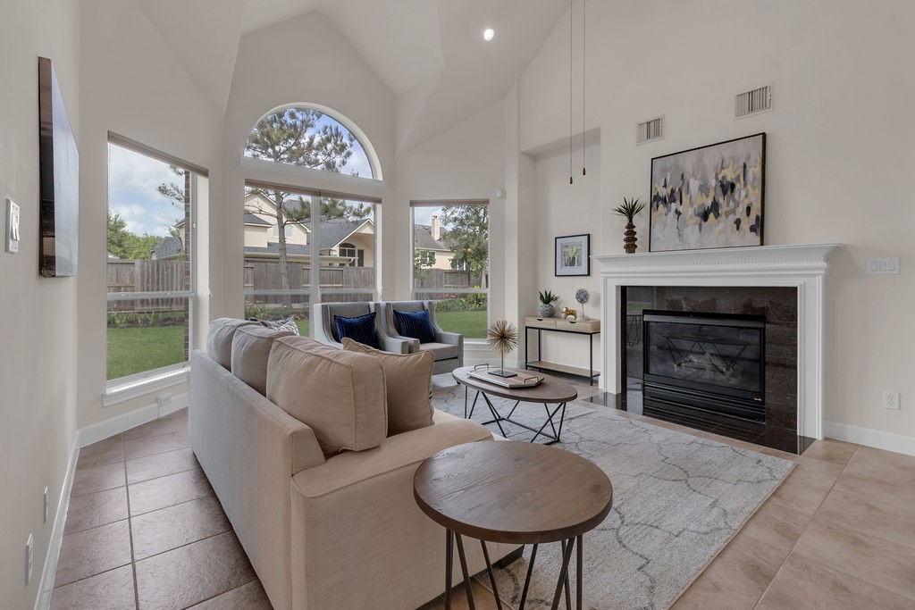 7306 Starflower Katy, TX 77494 - Photo 15 of 50 a living room with furniture a table and a fireplace