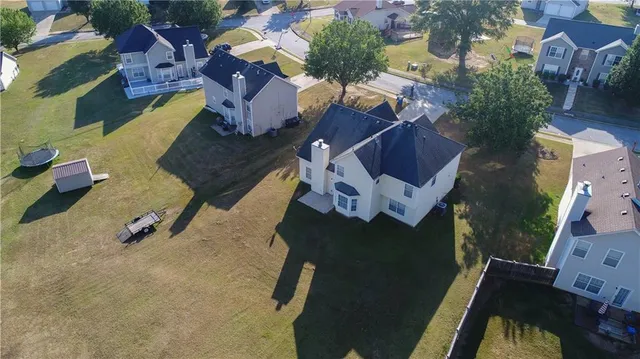 an aerial view of a house with a yard