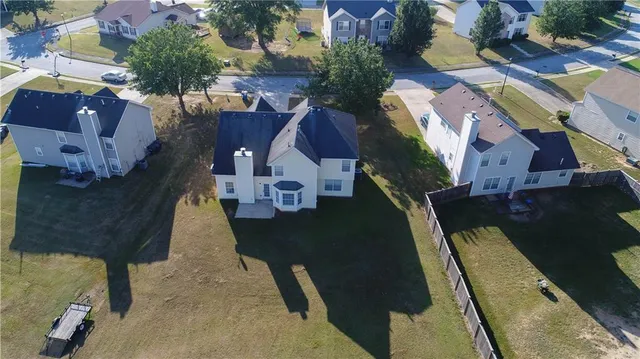 an aerial view of a house with a yard