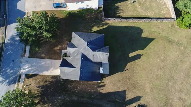 an aerial view of a house with garden space and street view