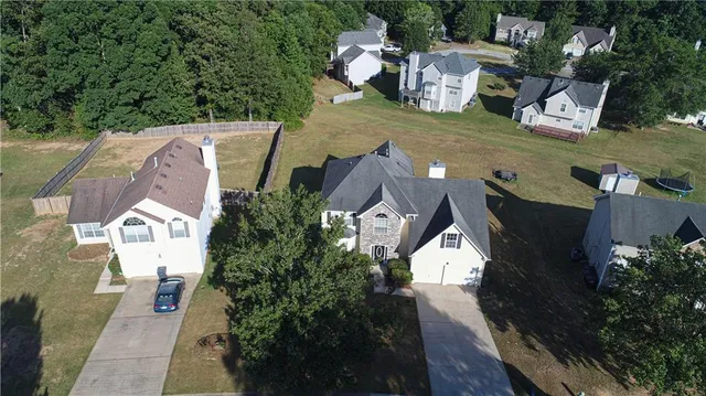 an aerial view of a house with a yard