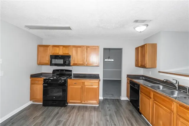 a kitchen with stainless steel appliances a stove and a refrigerator