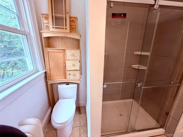 a bathroom with a glass door shower