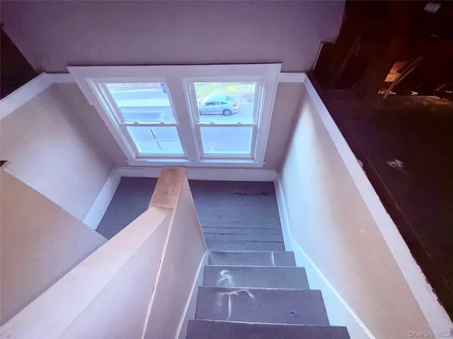 a view of an empty room with a windows