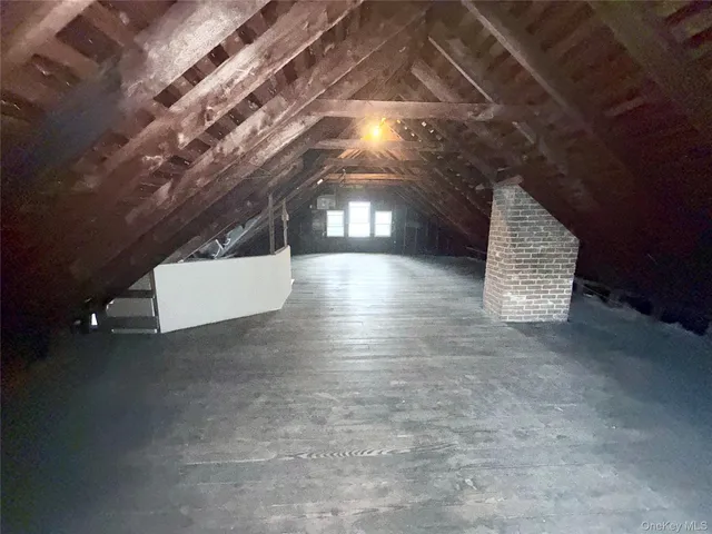 a view of a house with a yard and a tree