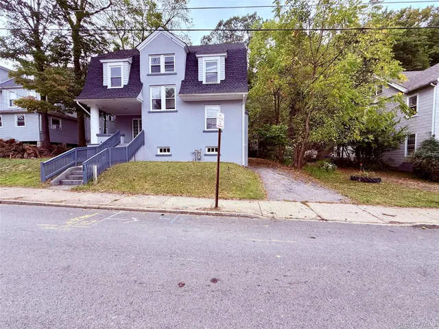 a view of a brick building next to a yard
