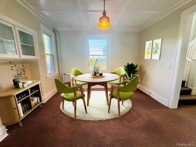 a dining room with furniture and window