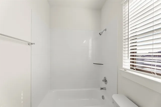 a bathroom with a bathtub and shower