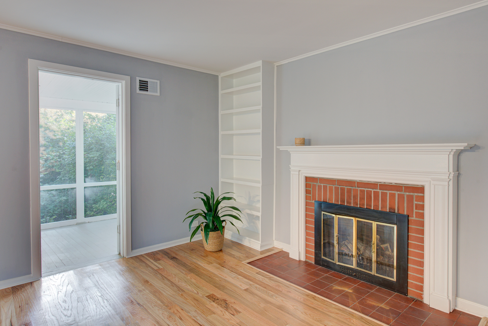 2360 Maple Road Homewood, IL 60430 - Photo 11 of 33 a living room with a fireplace and a potted plant