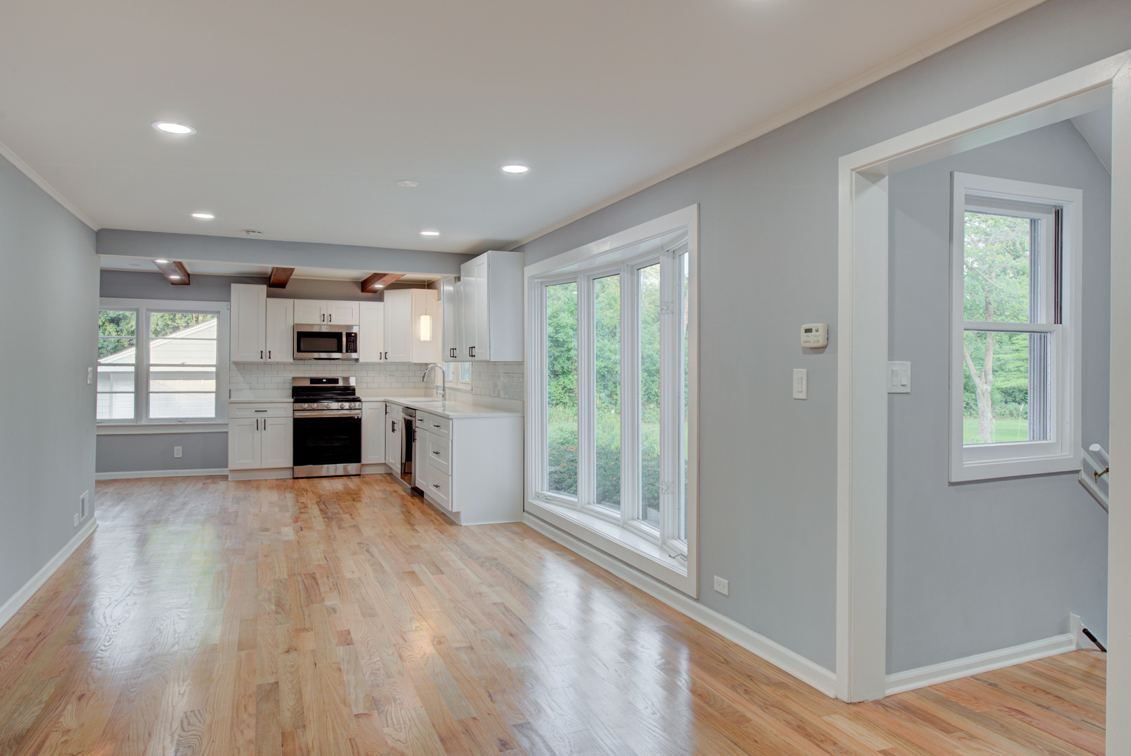 2360 Maple Road Homewood, IL 60430 - Photo 7 of 33 a view of a kitchen with wooden floor electronic appliances and windows