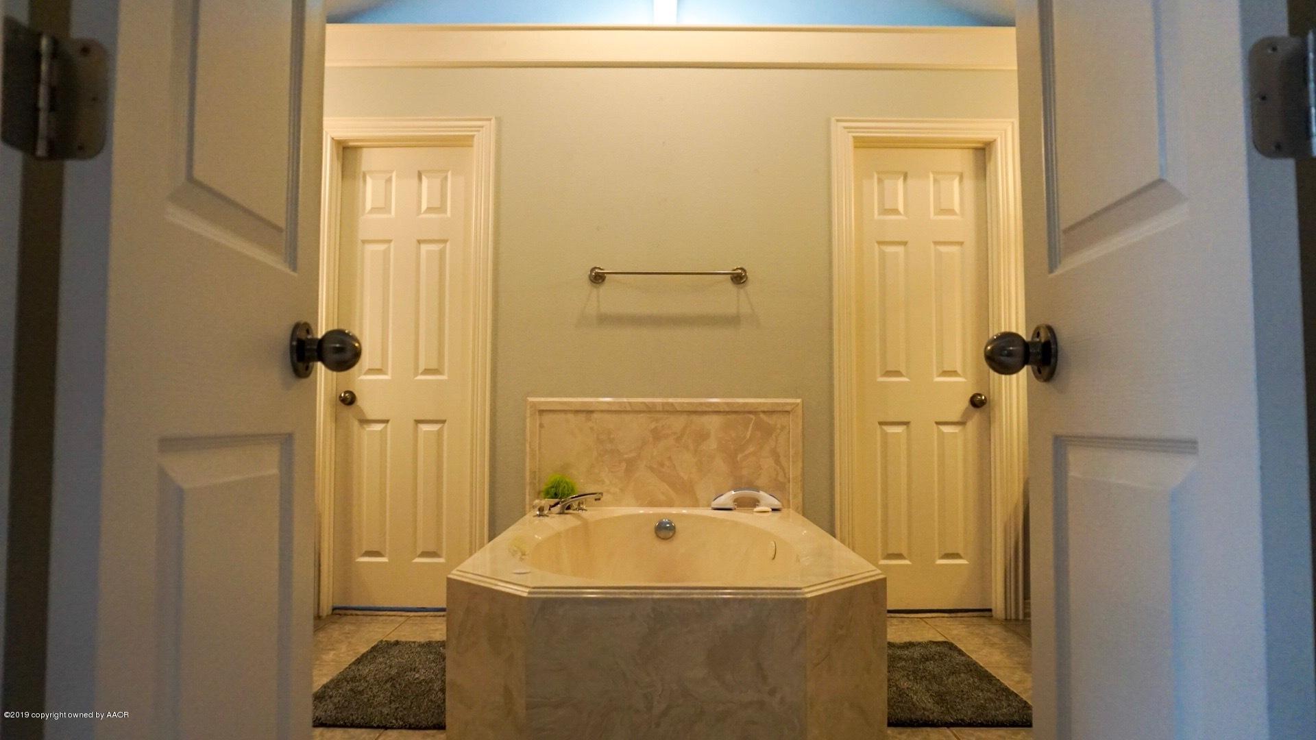 6605 Rally Road Amarillo, TX 79119 - Photo 11 of 21 a bathroom with a sink a toilet and shower