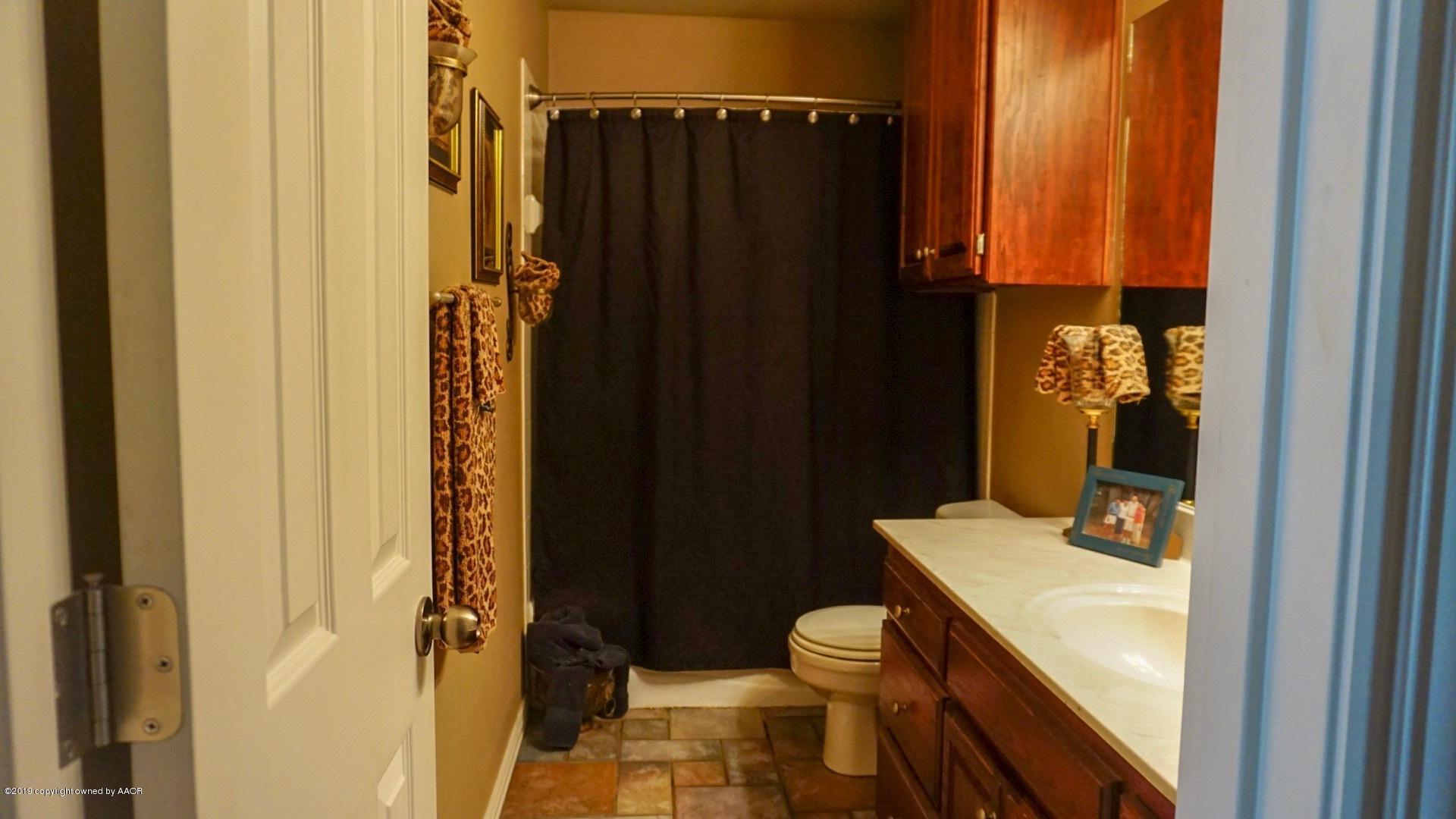 6605 Rally Road Amarillo, TX 79119 - Photo 14 of 21 a bathroom with a sink toilet and shower