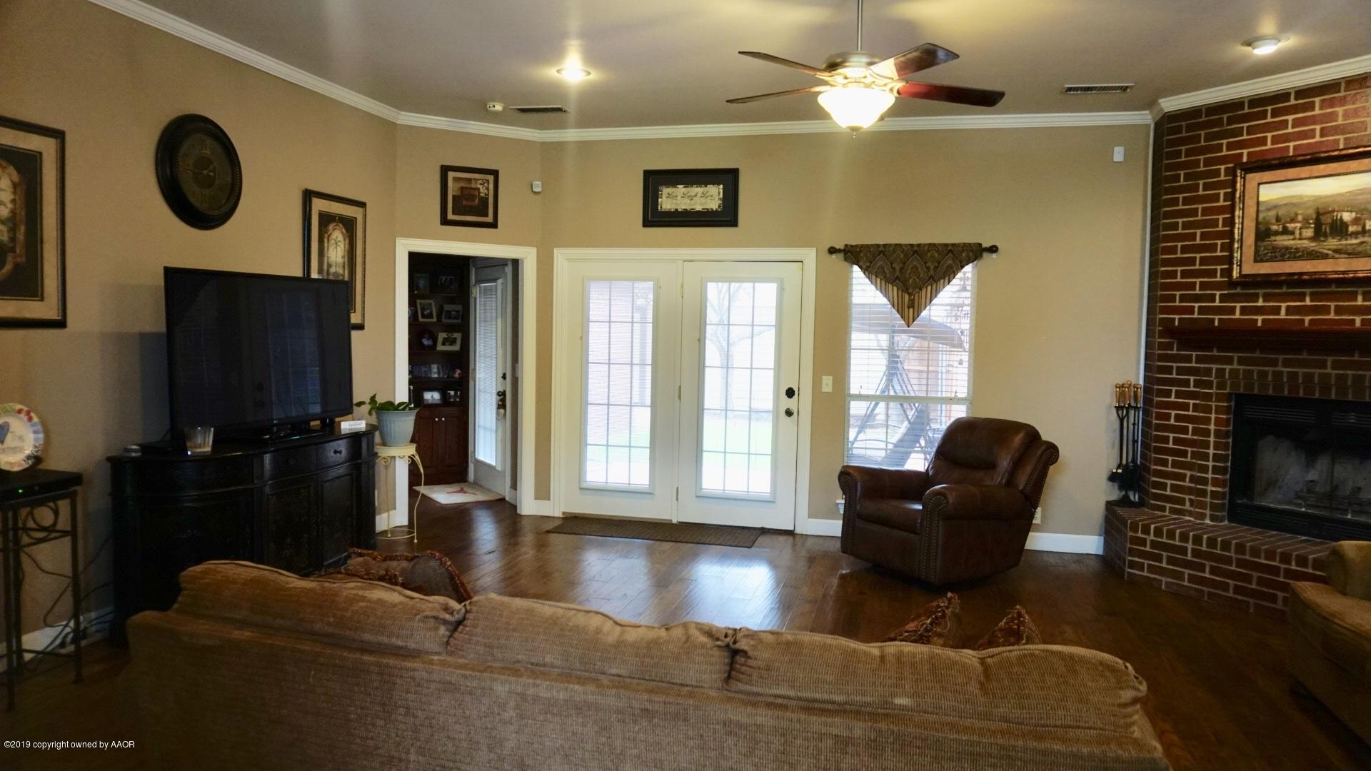 6605 Rally Road Amarillo, TX 79119 - Photo 4 of 21 a living room with furniture and a fireplace