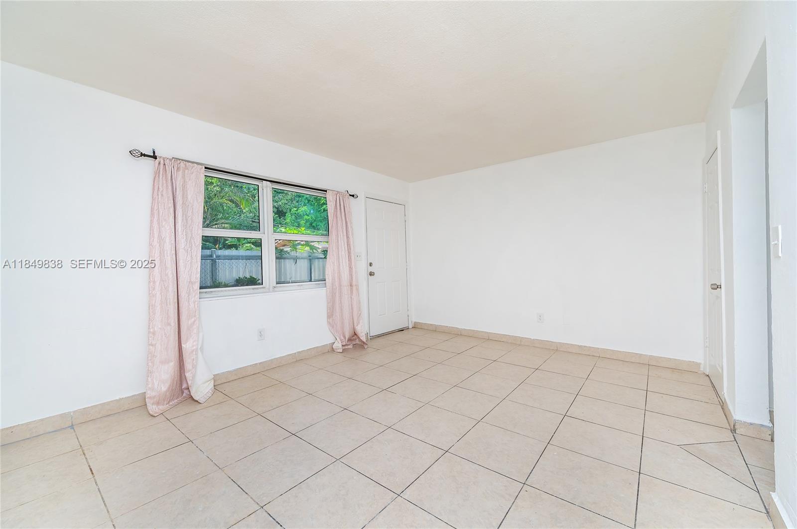520 Southwest Krome Terrace, Unit 1 Homestead, FL 33030 - Photo 11 of 27 a view of an empty room and window