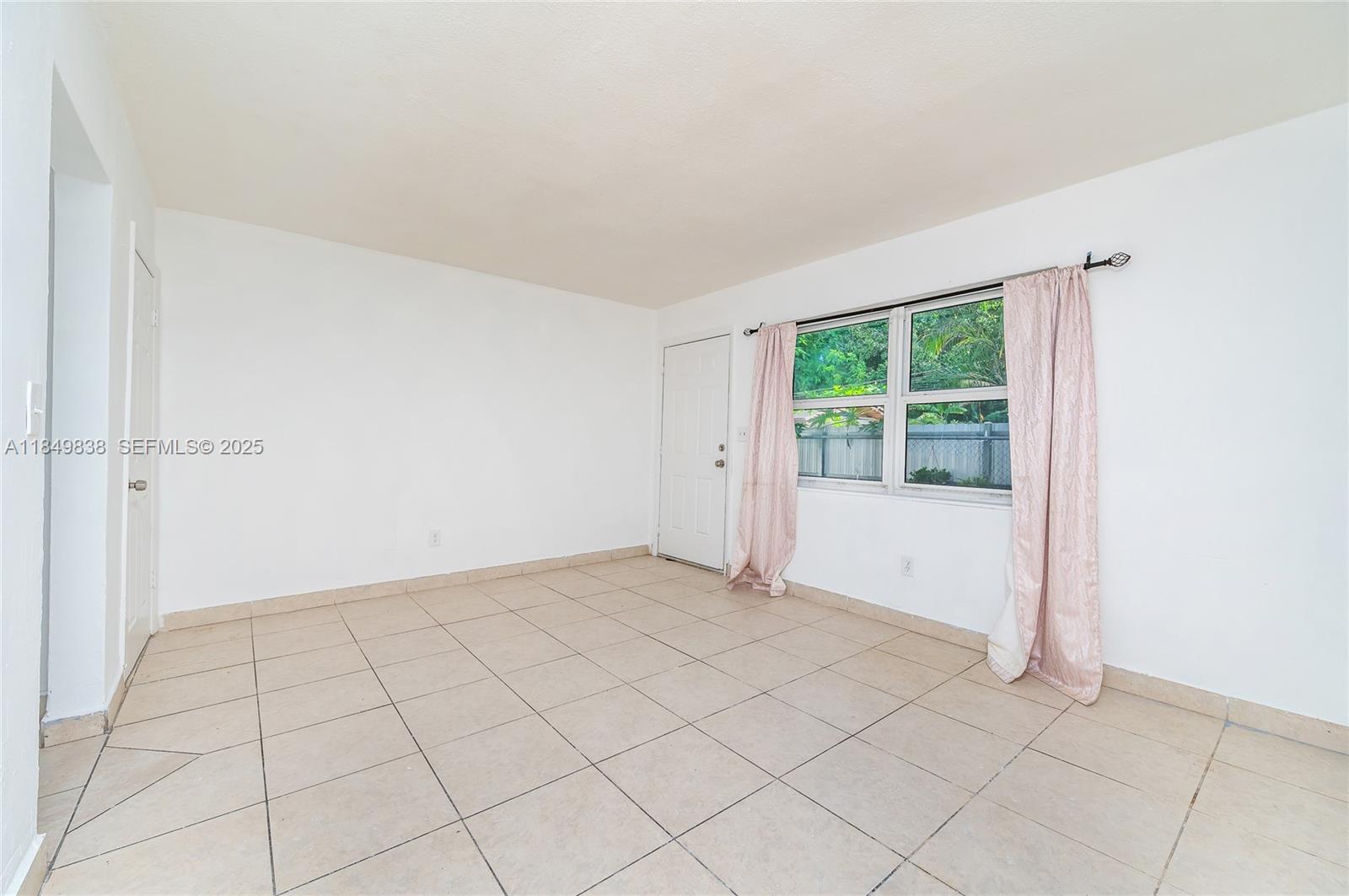 520 Southwest Krome Terrace, Unit 1 Homestead, FL 33030 - Photo 16 of 27 a view of an empty room and window