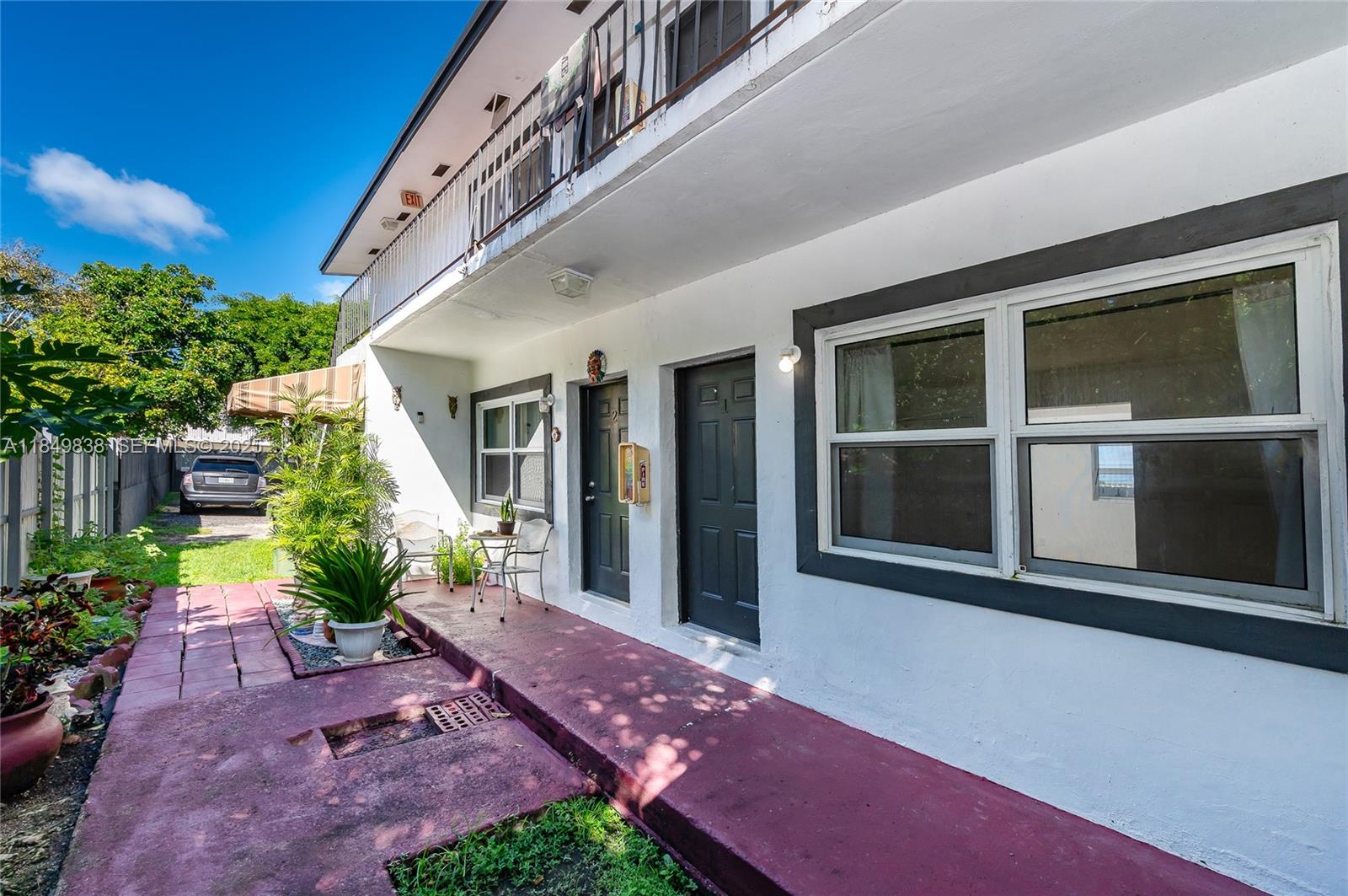 520 Southwest Krome Terrace, Unit 1 Homestead, FL 33030 - Photo 22 of 27 a view of an chairs and table in the patio