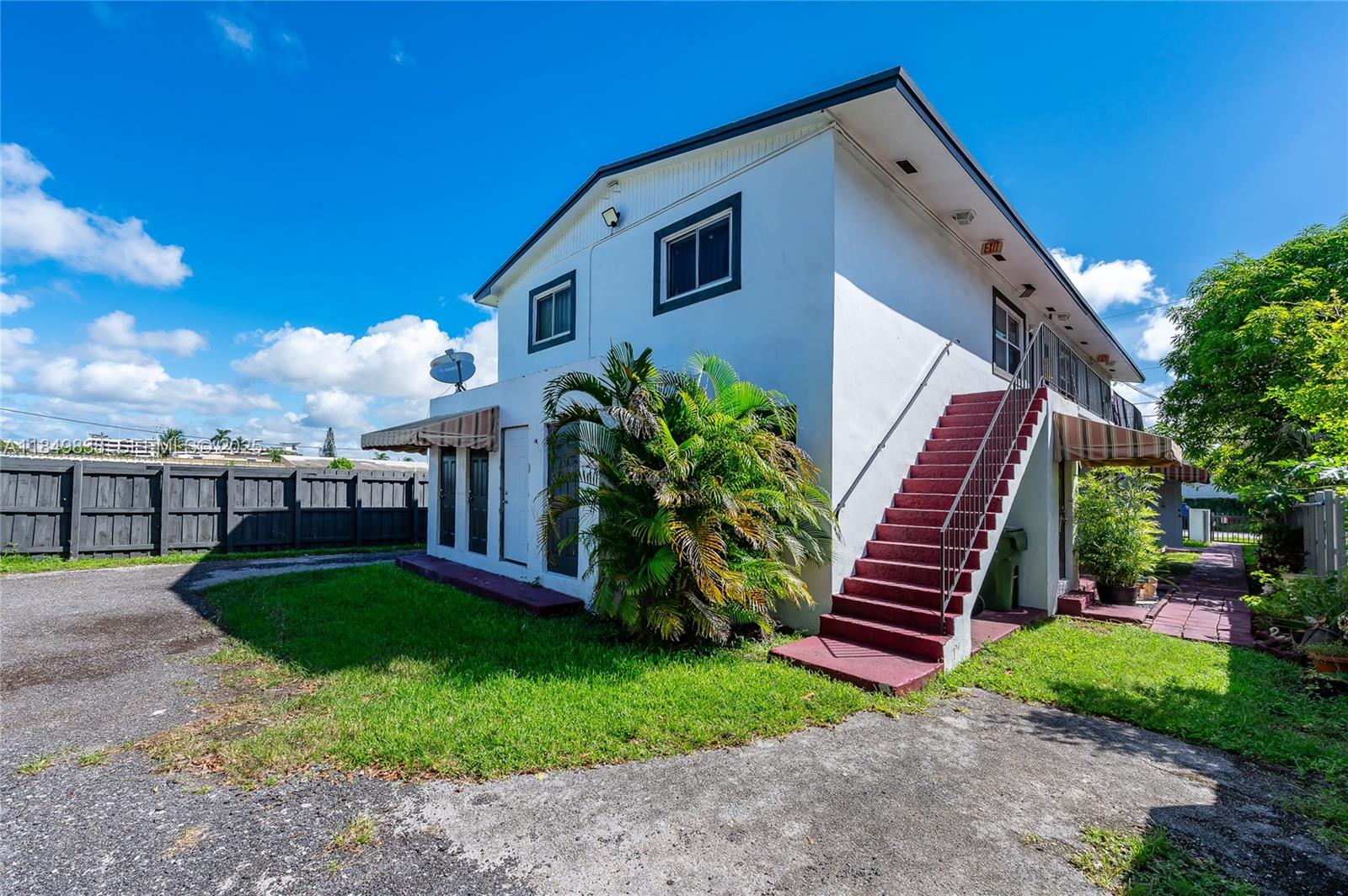 520 Southwest Krome Terrace, Unit 1 Homestead, FL 33030 - Photo 25 of 27 a front view of a house with garden