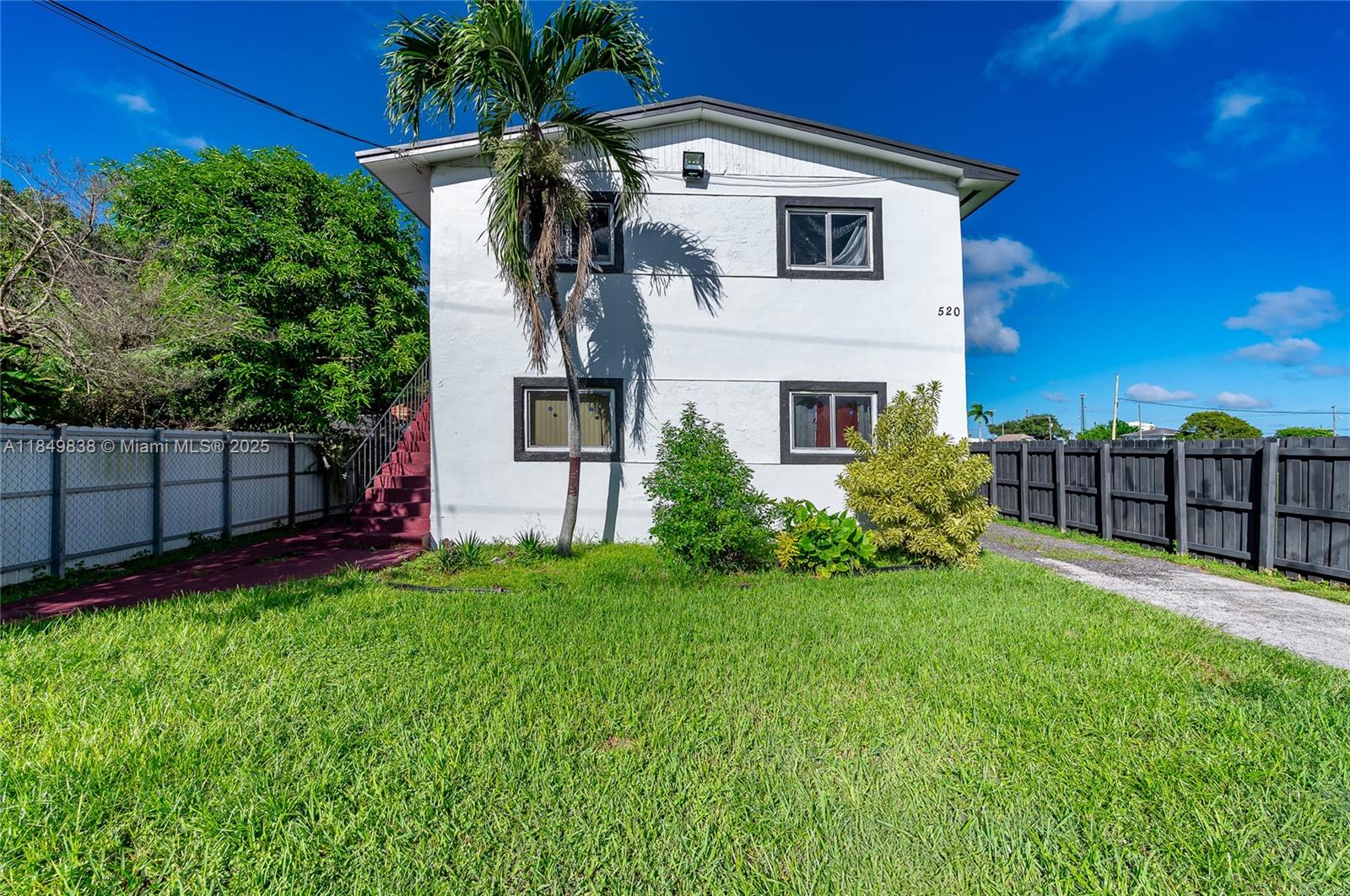 520 Southwest Krome Terrace, Unit 1 Homestead, FL 33030 - Photo 26 of 27 a front view of a house having yard and green space