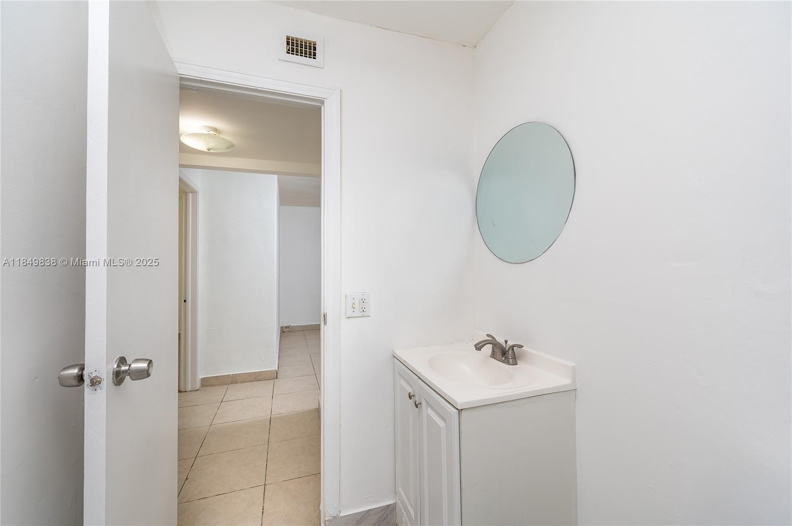 520 Southwest Krome Terrace, Unit 1 Homestead, FL 33030 - Photo 9 of 27 a bathroom with a sink and a mirror