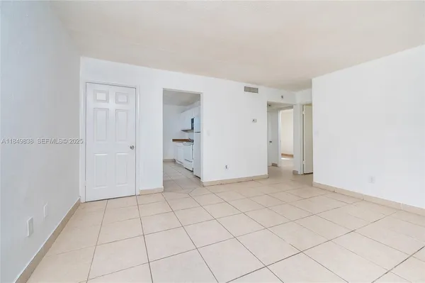 a view of an empty room and closet area