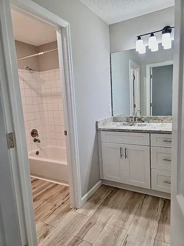 a bathroom with a sink a mirror and a bathtub