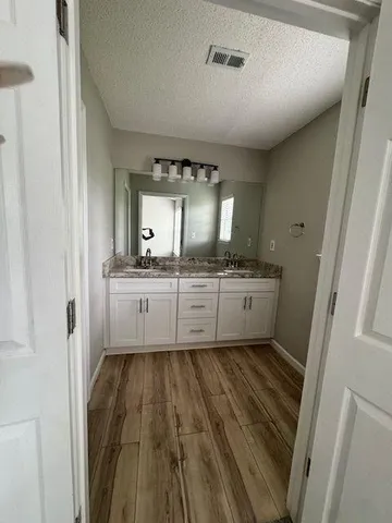 a bathroom with a sink a mirror and a toilet