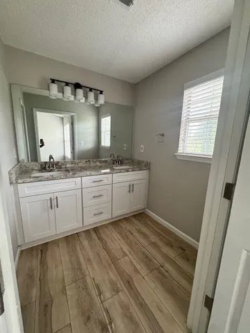 a bathroom with a double vanity sink and a mirror