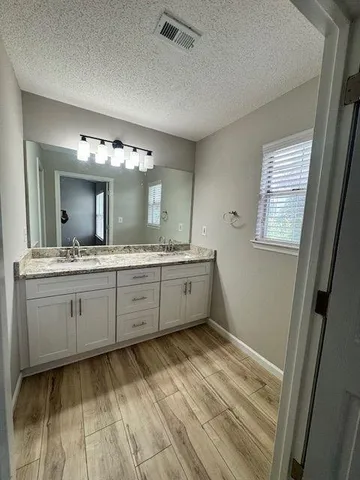 a spacious bathroom with a double vanity sink and a mirror