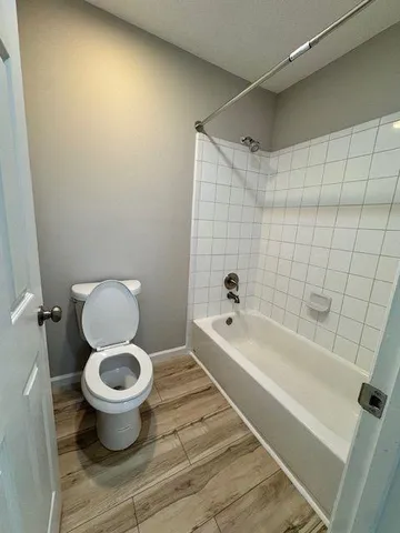 a bathroom with a toilet and a bathtub