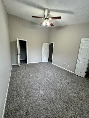an empty room with fan and window