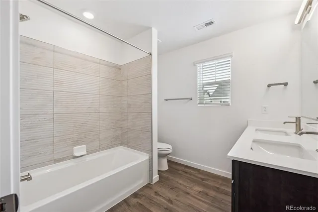 a bathroom with a bathtub a sink a toilet and a mirror