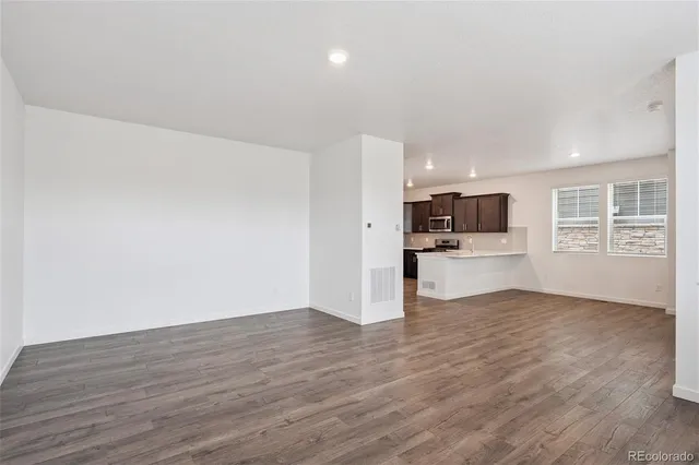 a view of kitchen with wooden floor and window