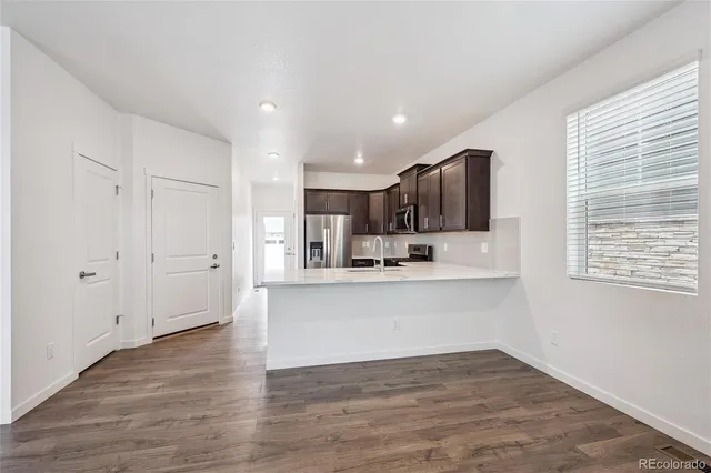 a view of kitchen with wooden floor and window
