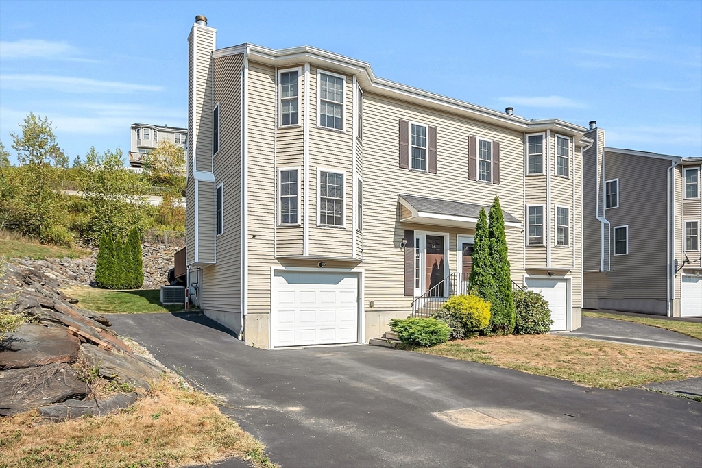 56 Honeysuckle Road Worcester, MA 01607 - Photo 1 of 27 a front view of a house with a yard