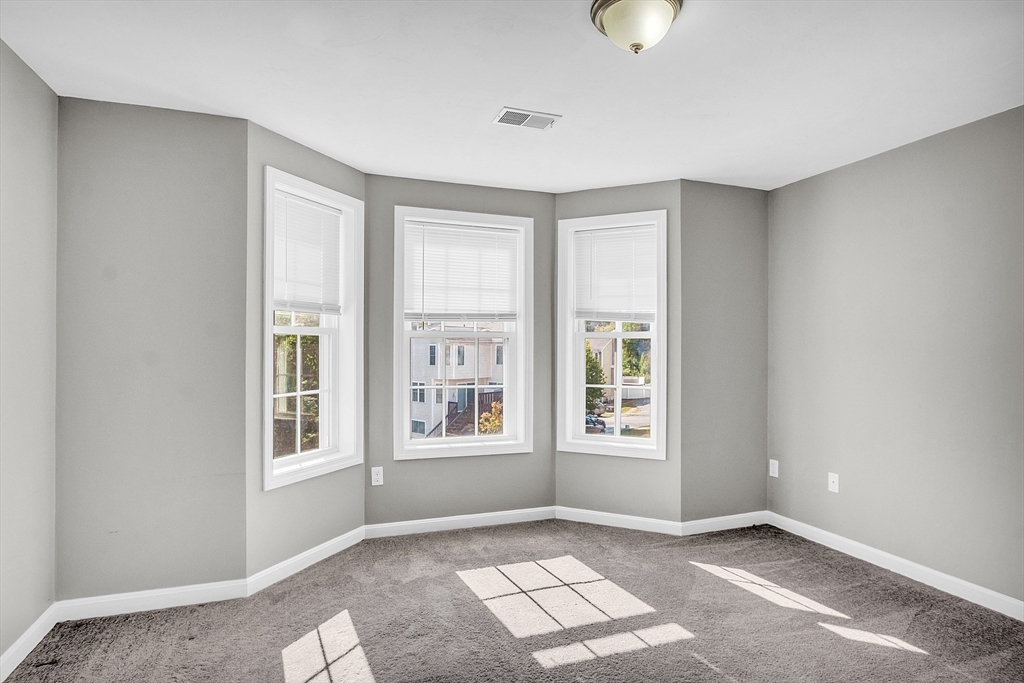 56 Honeysuckle Road Worcester, MA 01607 - Photo 13 of 27 an empty room with windows and closet
