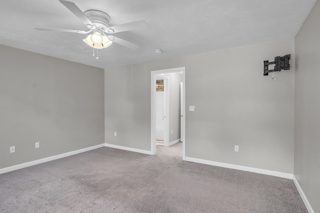 56 Honeysuckle Road Worcester, MA 01607 - Photo 22 of 27 an empty room with a chandelier fan