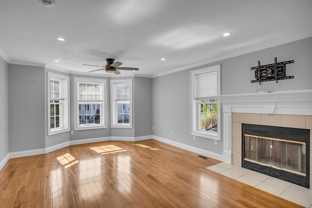 56 Honeysuckle Road Worcester, MA 01607 - Photo 5 of 27 a view of an empty room with a fireplace and a window