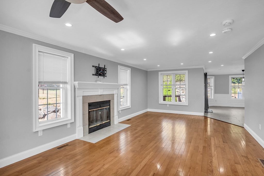56 Honeysuckle Road Worcester, MA 01607 - Photo 6 of 27 an empty room with windows and fireplace