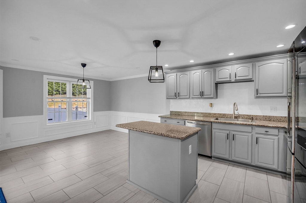 56 Honeysuckle Road Worcester, MA 01607 - Photo 8 of 27 a kitchen that has a sink and a stove in it