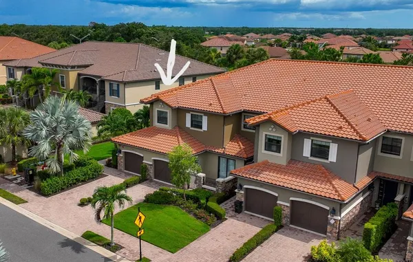 an aerial view of a house with a yard