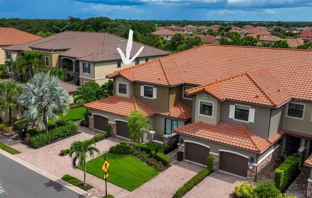 an aerial view of a house with a yard